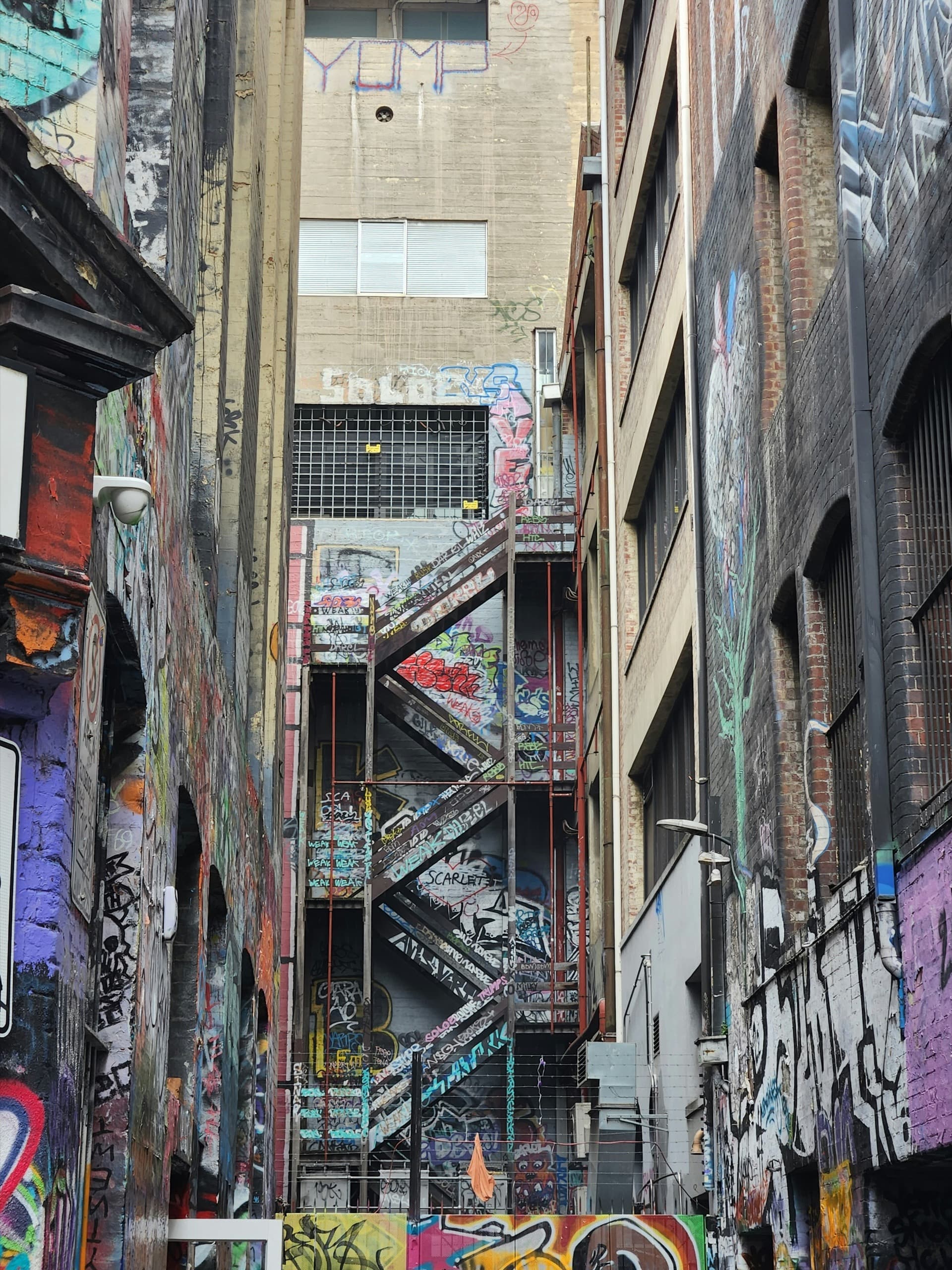 Graffiti-covered fire-escape staircase in a Melbourne laneway